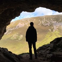 This is a picture of me looking out of a cave in Ullapool. 