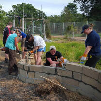 Volunteers putting up bricks