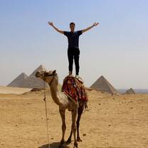 Standing on camel, Great Pyramids of Giza, Cairo Egypt