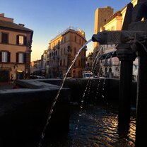 Piazza San Sisto during Christmas time. Fontana Grande; A fountain in middle of a busy center.