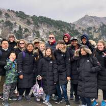 Picture of our class on the Great Wall of China - The day before we visited the Great Wall, it unexpectedly snowed in Beijing. We were not prepared for this weather and did not bring adequate clothes, but luckily we were able to get warm coats before our visit. The snow made the Great Wall look even more magical!