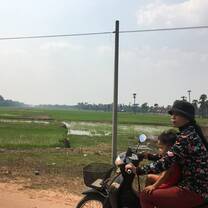 woman and child on motorbike in the countryside