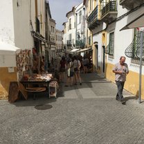 A picture of a street in Evora with all of the local street shops!