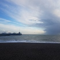 View of the English Channel and Brighton Pier where you can play carnival games and ride on carnival rides.