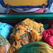 wearing traditional dress in the back of an Indian taxi—rickshaw