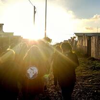 Volunteers walking into the distance during sunset 