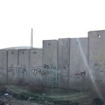 Graffiti on the separation barrier, just next to the checkpoint in between Pisgat Ze'ev and Hizma. Includes "GHETTO" and "BOSS" with the final two letters underlined.