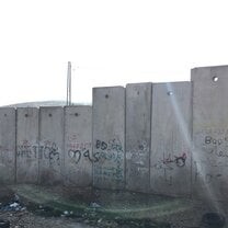Graffiti on the separation barrier, just next to the checkpoint in between Pisgat Ze'ev and Hizma. Includes "GHETTO" and "BOSS" with the final two letters underlined.
