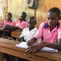 Ugandan school kids studying in class