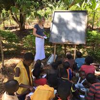 Volunteer teaching in an outdoor classroom in Uganda