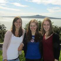 Three girls stand in a group 
