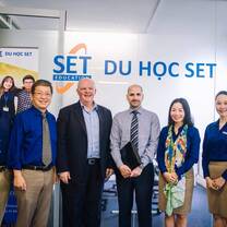 People smiling in front of the company name 