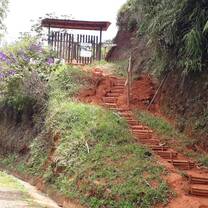 Wooden entrance gate with steps made on a hill