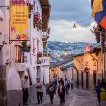 historic buildings with cobble streets and mountains in the background