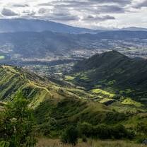 green mountains with cloudy skies