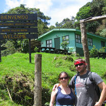 Woman and man in front of farm house in Costa Rica