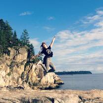 Girl jumping on cliff