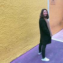 Woman standing in front of colorful walls