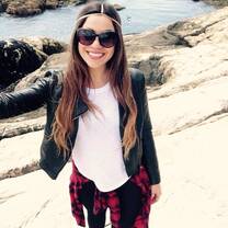 Girl standing on rock on beach