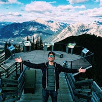 Man standing in front of mountains