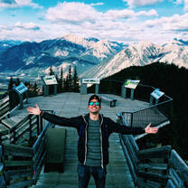 Man standing in front of mountains