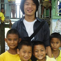 Volunteer smiling with children in Thailand.