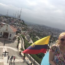 Standing in front of the Ecuadorian flag with a view of the city of Guayaquil, Ecuador