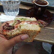 A pesto sandwich with a side of Greek coffee