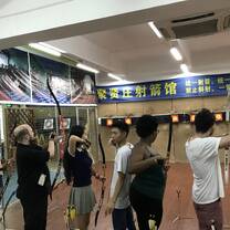 people doing archery indoors