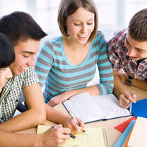 group of students reading from a book 