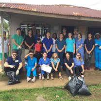 The group picks up trash on the street in a small community. 