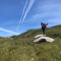 woman doing yoga on rock 