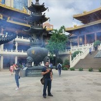 A traditonal Chinese temple with looming skyscrappers in the background