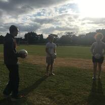 students playing sport on field 