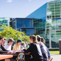 Students on campus outside a cafe
