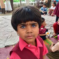 A little girl with beautiful blue eyes from one of the local schools. 