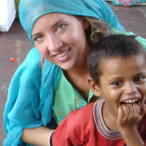 Volunteer smiling with a young boy in India