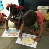 Students in Udaipur coloring pictures in class with STEP Volunteers