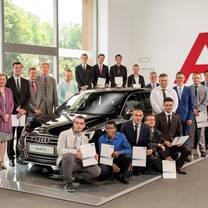 Group of interns in front of audi