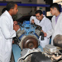 Three men working on a car