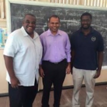 Group of People in front of chalkboard