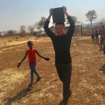 helping watering the trees at a local primary school