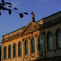 This photograph was taken while the Sun was setting on July 11th. Light and shadows cast by the Sun emphasize the beautiful architecture of Queen's College.