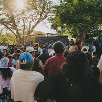 Imagine sunlight streaming through the trees illuminating a crowd of people gathered below.