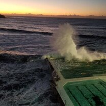 Bondi Sunrise The sun rising in the east next to the Icebergs at Bondi Beach. The waves are crashing into the pool, which is a common, yet beautiful sight to see.