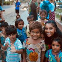 Volunteer from United Kingdoms posing with street children in Jaipur, India with The Tarzan Way