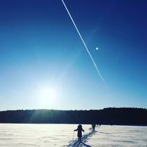 When we were skiing on a icy, quiet lake, a jet plane happened to fly by and left a long long trail. 