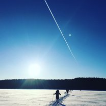 When we were skiing on a icy, quiet lake, a jet plane happened to fly by and left a long long trail. 