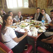 A group of people eating together at a table in Jordan