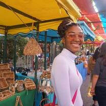 A CET student smiling in a marketplace